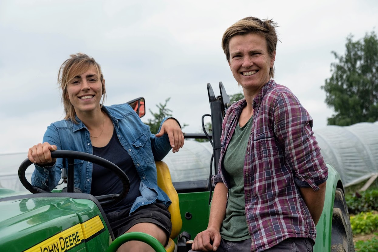 Foto toont Charlotte en Hilde op een tractor